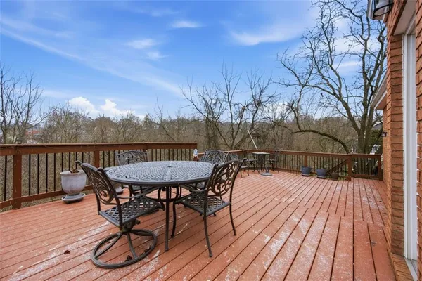 a view of a balcony with chairs and wooden floor