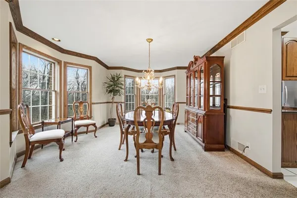 a dining room with furniture water view and a chandelier