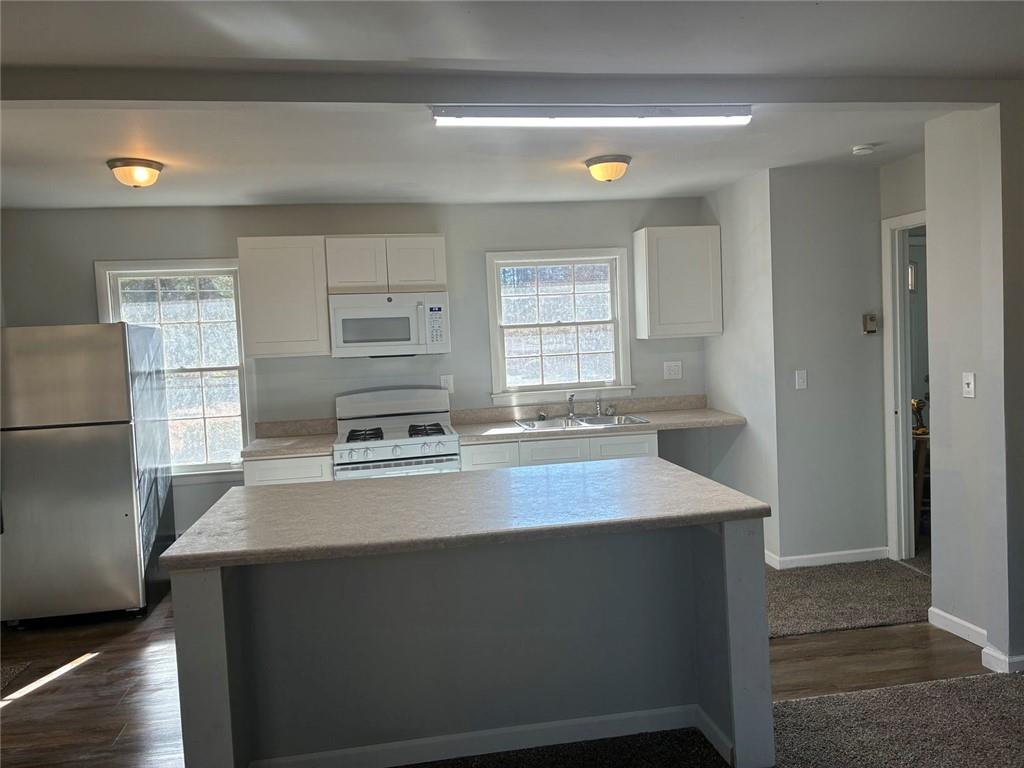 3992 Maplewood Drive Decatur, GA 30035 - Photo 15 of 44 a kitchen with kitchen island a sink stove and refrigerator