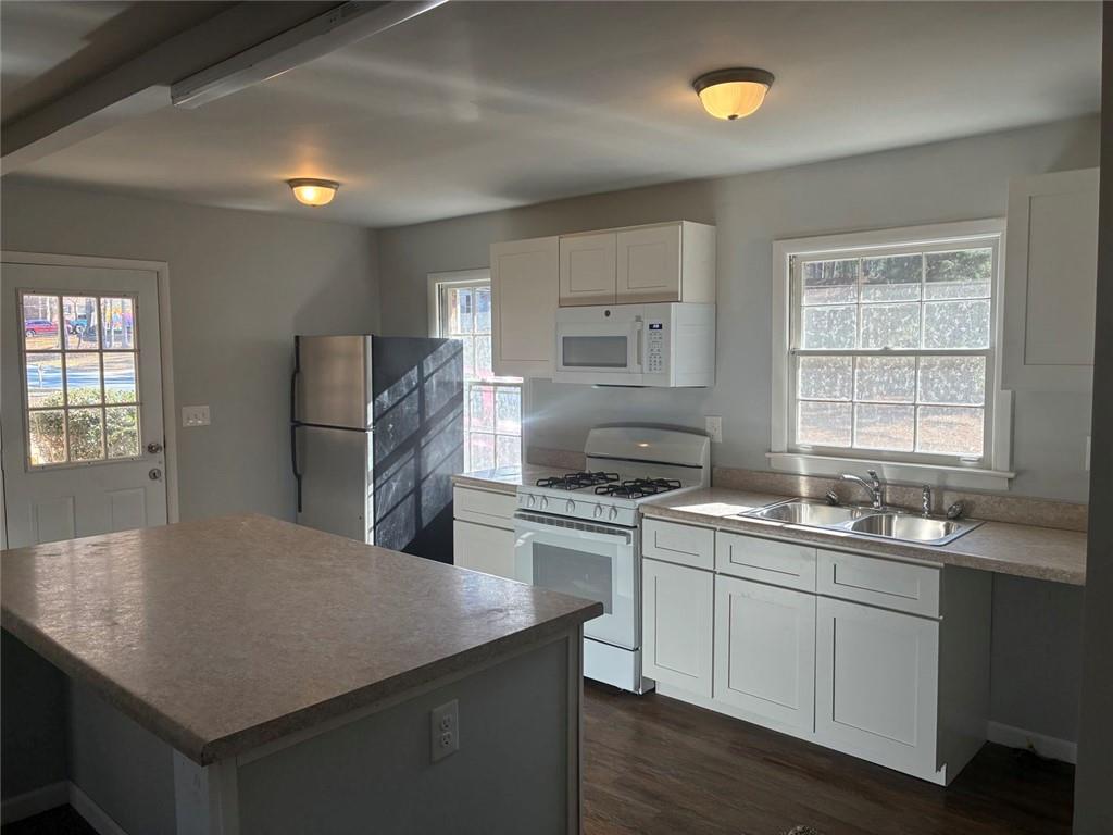 3992 Maplewood Drive Decatur, GA 30035 - Photo 16 of 44 a kitchen with a stove a sink a refrigerator and cabinets