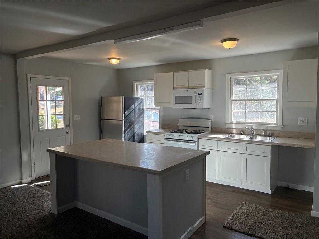 3992 Maplewood Drive Decatur, GA 30035 - Photo 17 of 44 a kitchen with stainless steel appliances granite countertop a sink stove and refrigerator