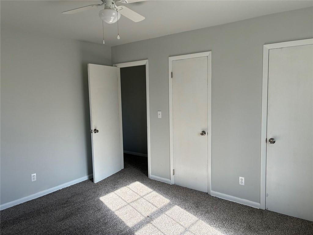3992 Maplewood Drive Decatur, GA 30035 - Photo 37 of 44 a view of an empty room with window and chandelier fan