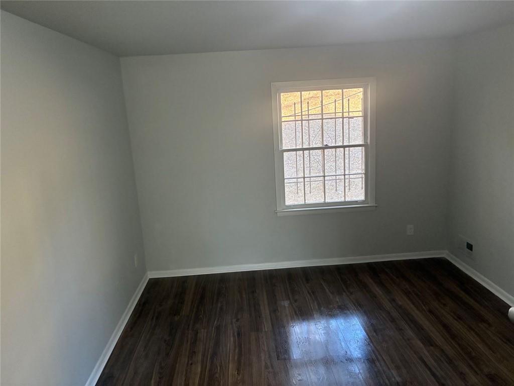 3992 Maplewood Drive Decatur, GA 30035 - Photo 7 of 44 an empty room with wooden floor and windows