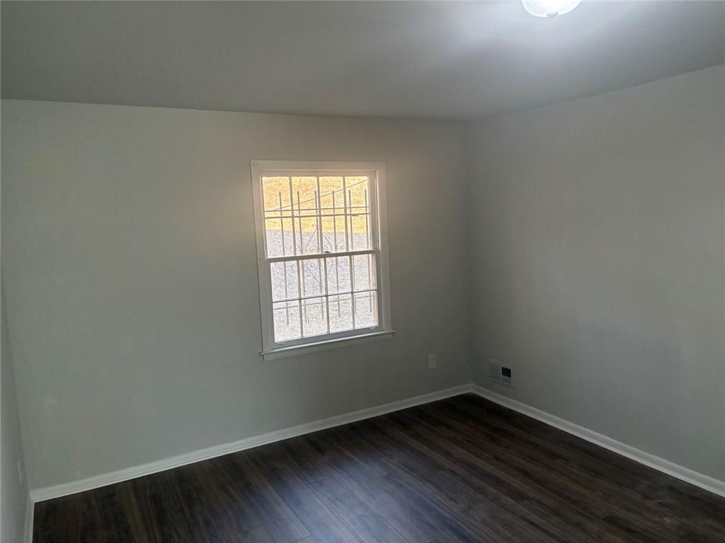 3992 Maplewood Drive Decatur, GA 30035 - Photo 9 of 44 an empty room with wooden floor and windows