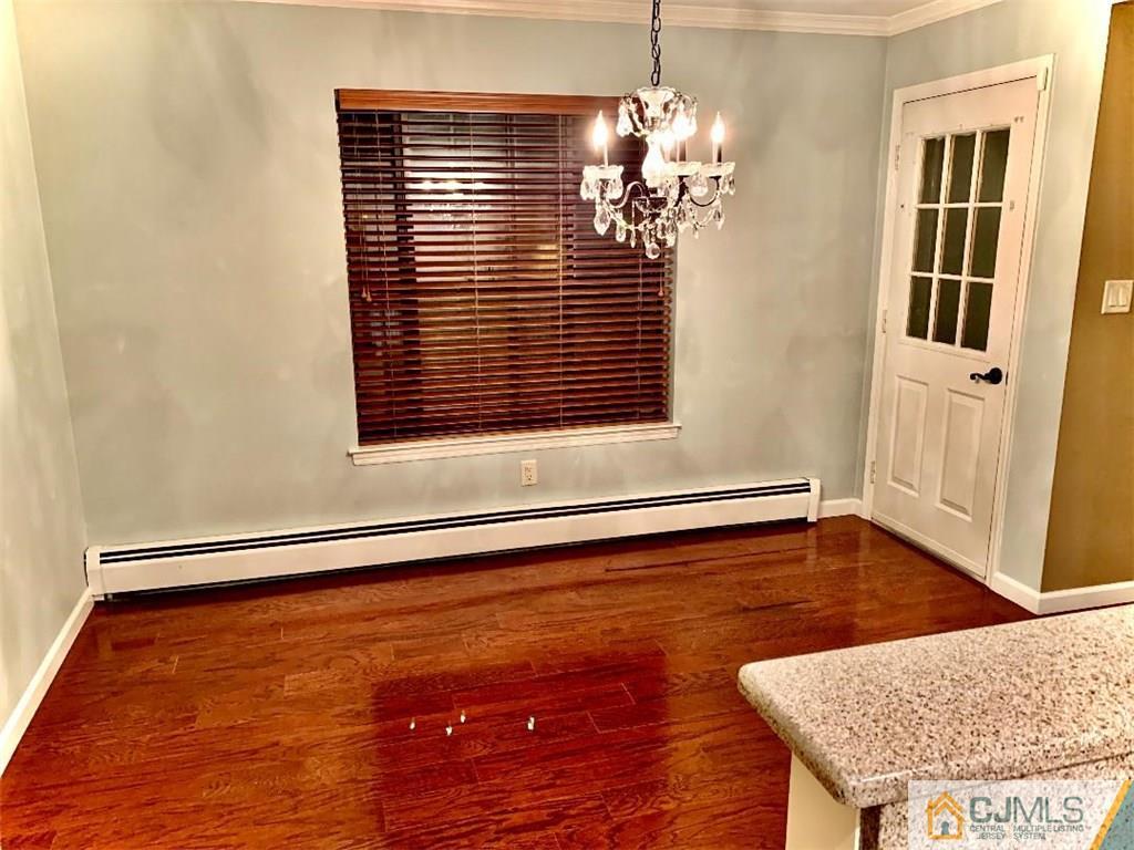 14 Kensington Road, Unit G Chatham, NJ 07928 - Photo 4 of 10 a view of an empty room with wooden floor and a window