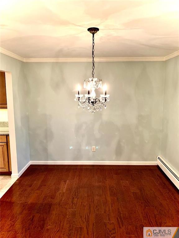 14 Kensington Road, Unit G Chatham, NJ 07928 - Photo 5 of 10 a view of a room with wooden floor and chandelier