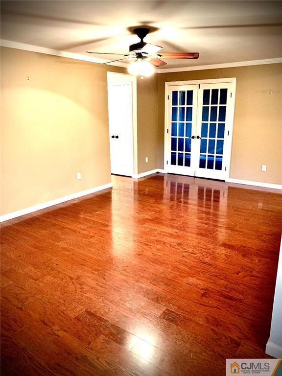 14 Kensington Road, Unit G Chatham, NJ 07928 - Photo 6 of 10 a view of an empty room with window and wooden floor