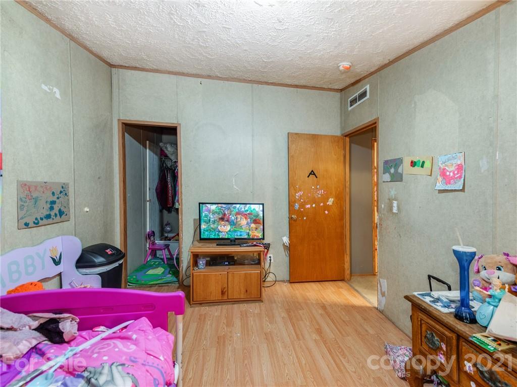785 Thompson Road Salisbury, NC 28147 - Photo 11 of 23 a bedroom with furniture and a flat screen tv