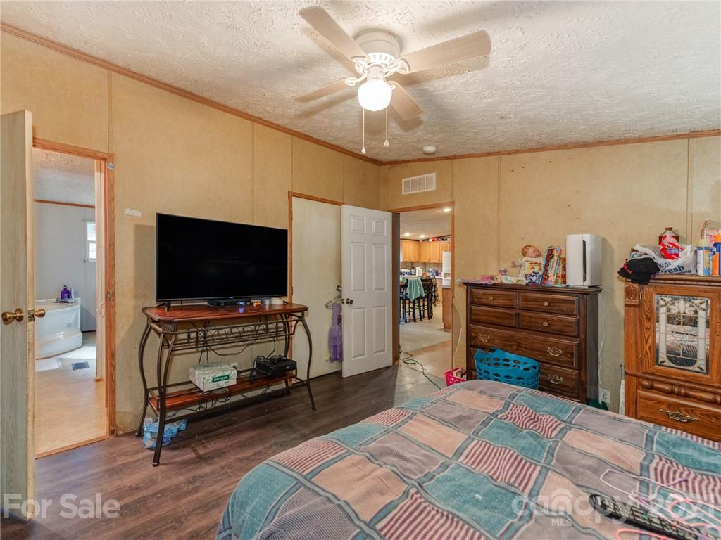 785 Thompson Road Salisbury, NC 28147 - Photo 14 of 23 a bedroom with a bed and a flat screen tv