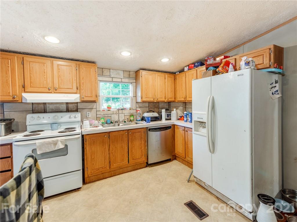 785 Thompson Road Salisbury, NC 28147 - Photo 8 of 23 a kitchen with white cabinets and white appliances
