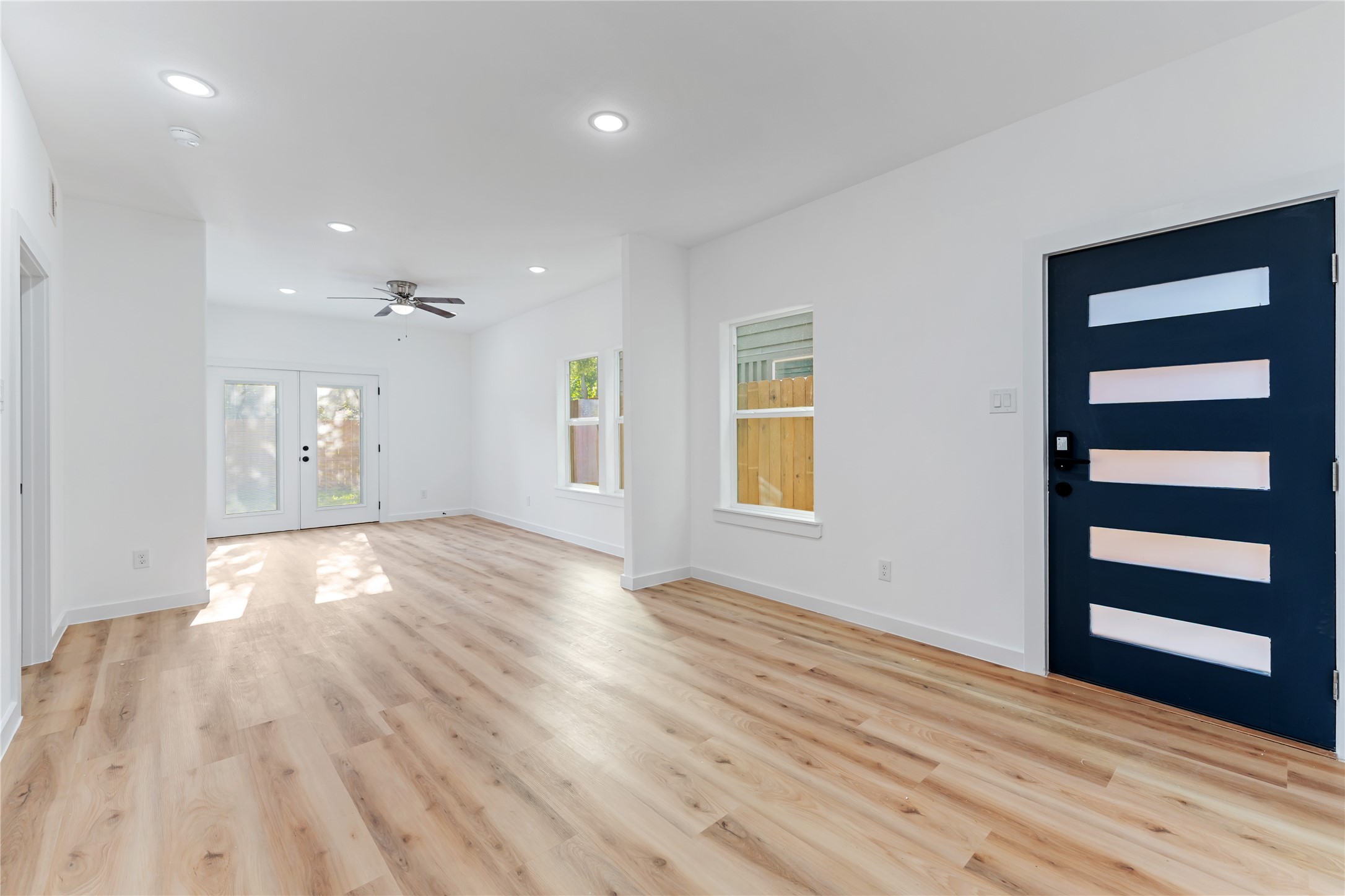 9326 Firnat Street Houston, TX 77016 - Photo 11 of 30 a view of empty room with wooden floor and window