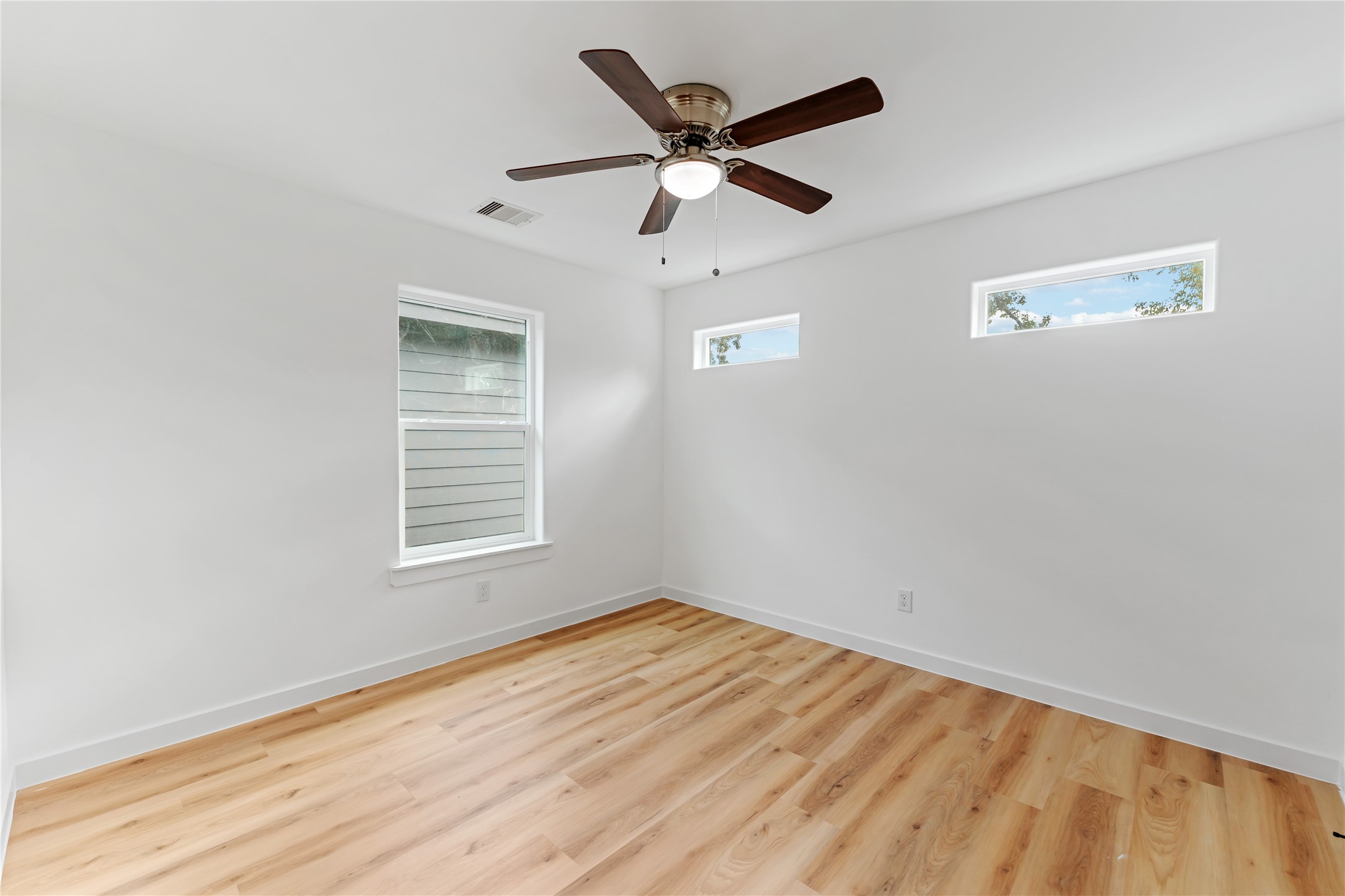 9326 Firnat Street Houston, TX 77016 - Photo 19 of 30 a view of empty room with wooden floor
