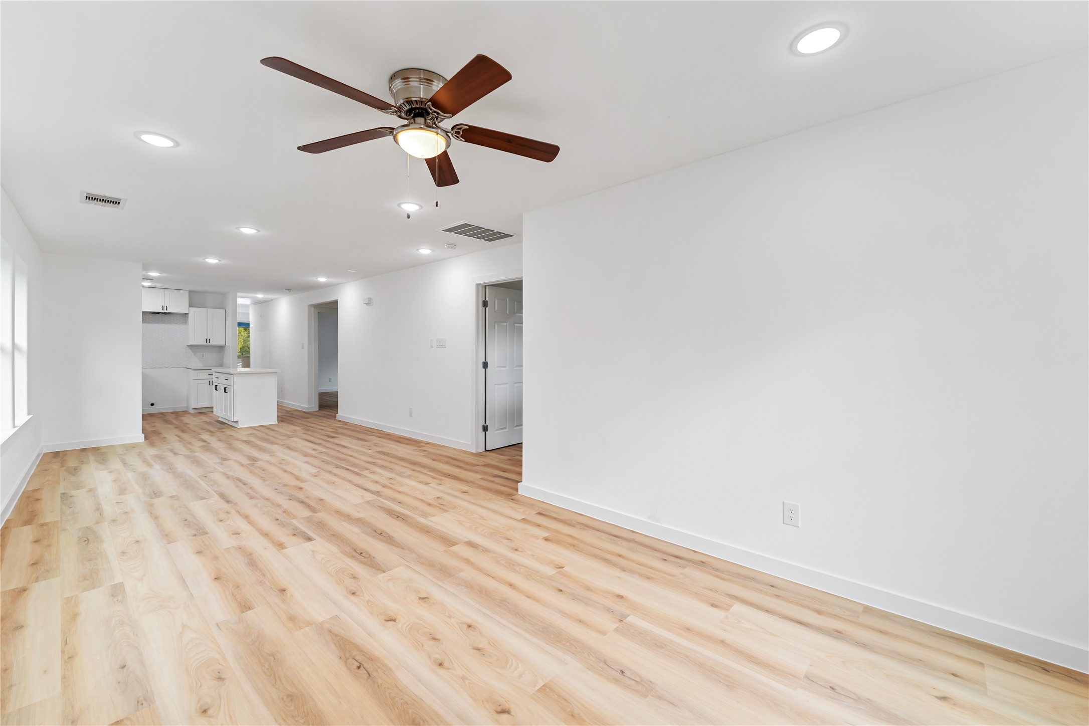 9326 Firnat Street Houston, TX 77016 - Photo 7 of 30 a view of empty room with wooden floor and ceiling fan