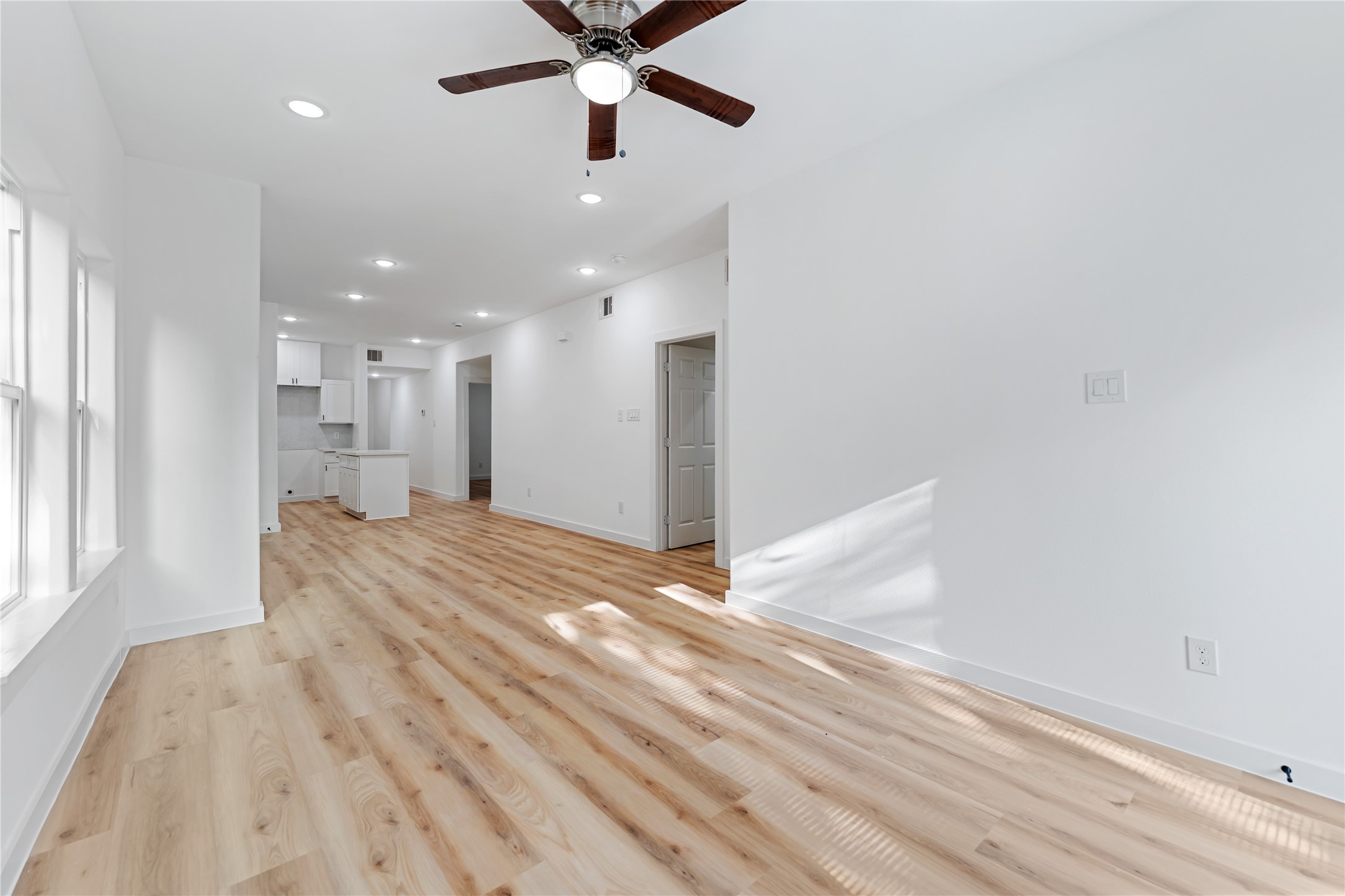 9326 Firnat Street Houston, TX 77016 - Photo 9 of 30 an empty room with wooden floor and a window