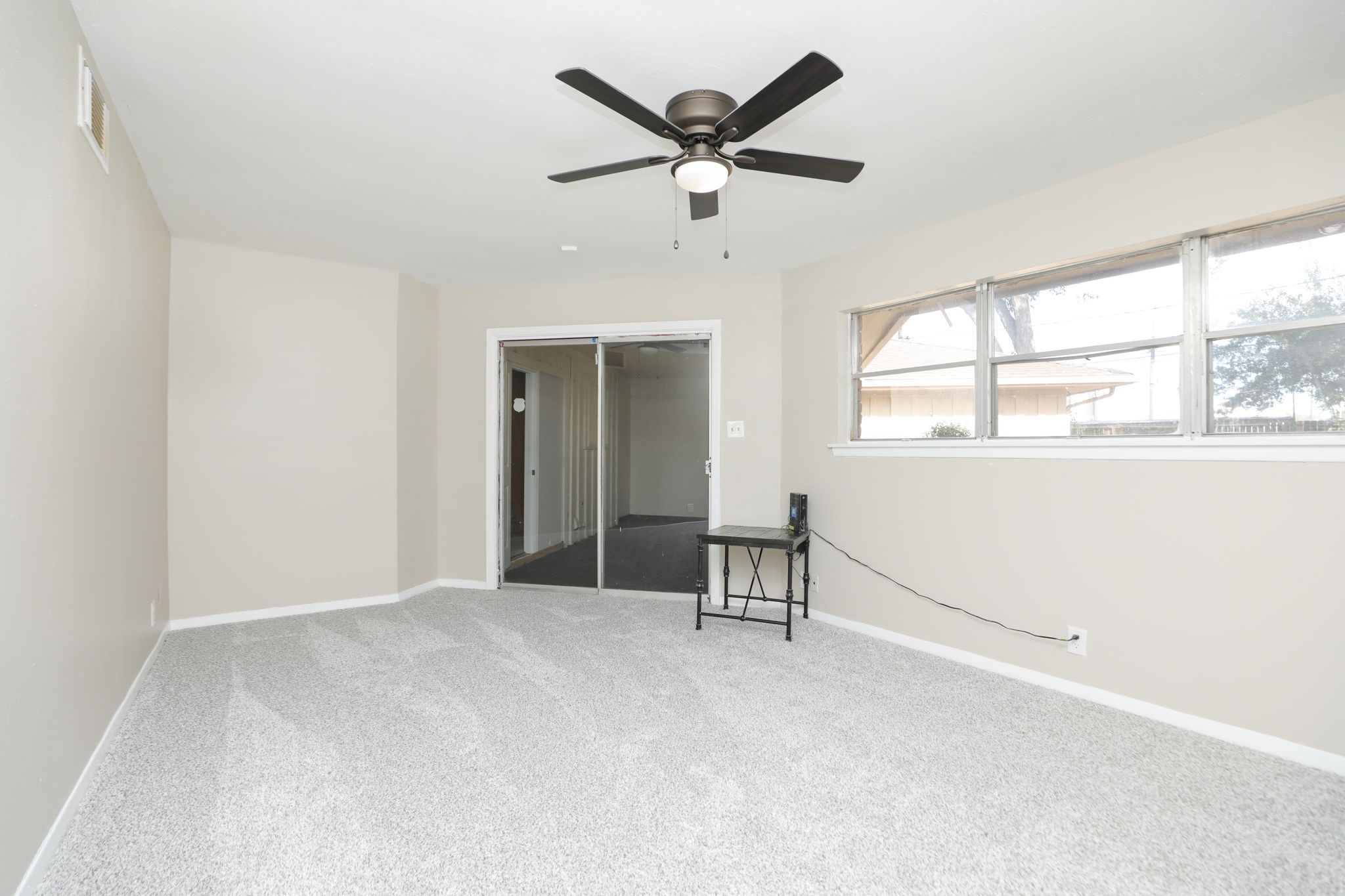 8235 Dover Street Houston, TX 77061 - Photo 24 of 36 an empty room with windows and fan