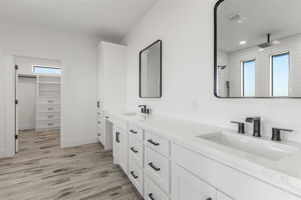 2311 Parker Road Wichita Falls, TX 76310 - Photo 21 of 32 a spacious bathroom with double vanity a mirror and a shower