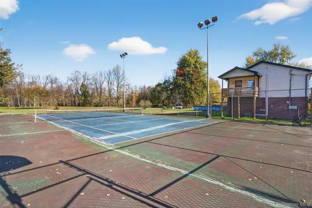 a view of a tennis ground in front of a building