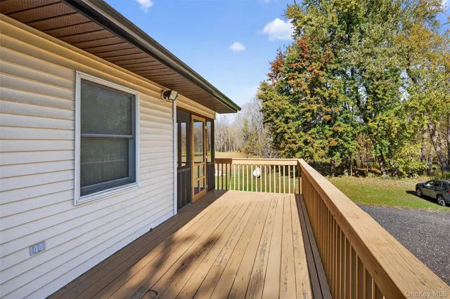a view of balcony with wooden floor