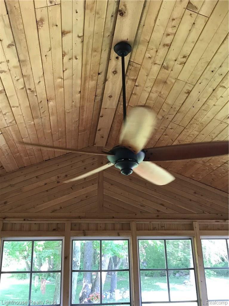 7150 Denton Hill Road Fenton, MI 48430 - Photo 20 of 47 Vaulted ceiling in porch shows off the tongue and groove cedar and ceiling fan