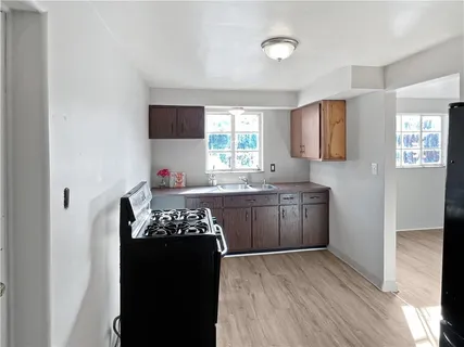 a kitchen with a refrigerator and a stove top oven