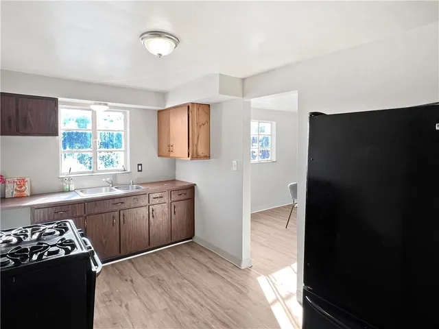 a kitchen with a refrigerator and a sink