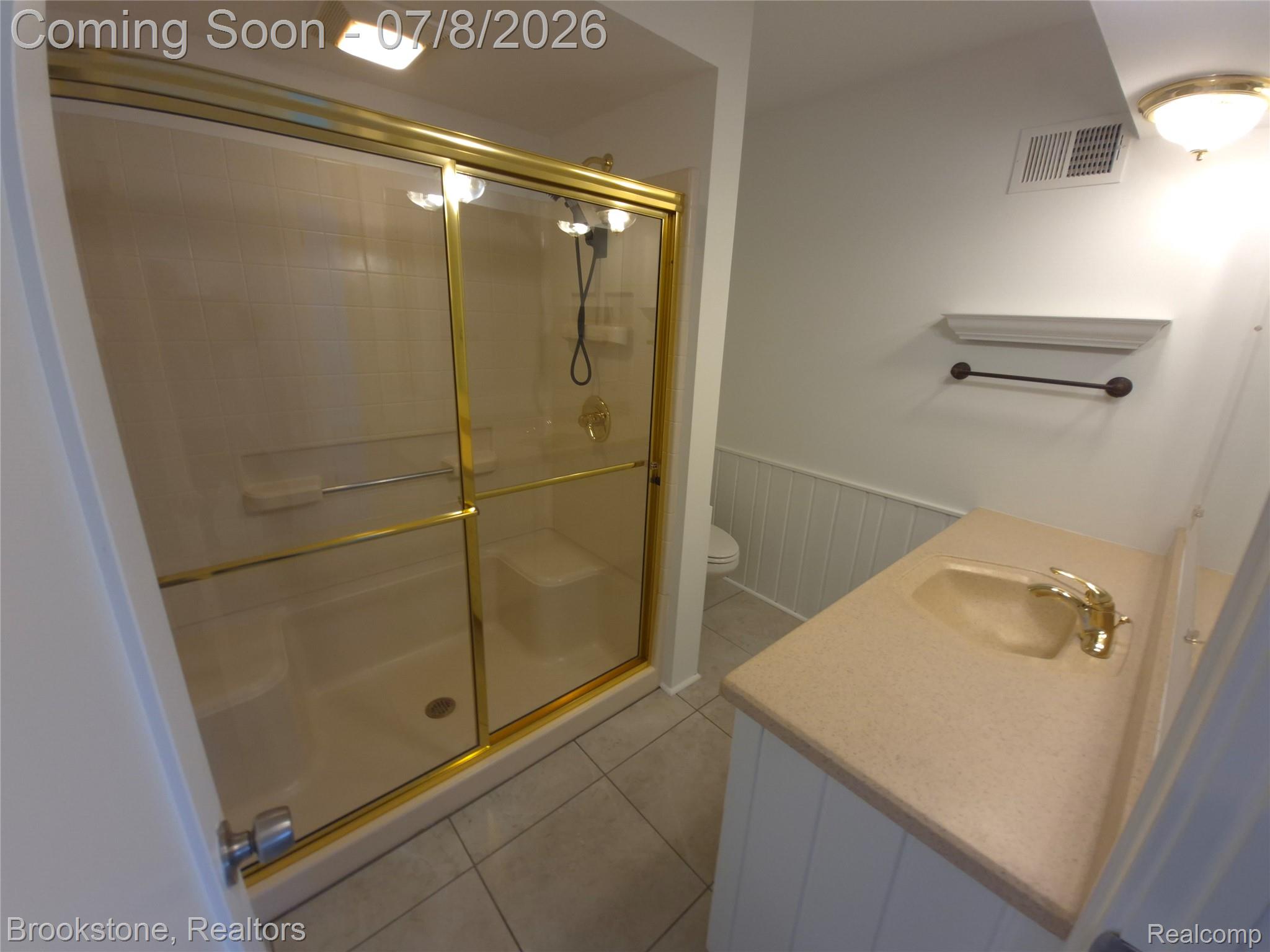 4140 South Henderson Road Davison, MI 48423 - Photo 58 of 98 Bathroom with a gold-framed glass shower enclosure, integrated shower seat, and a tiled shower surround