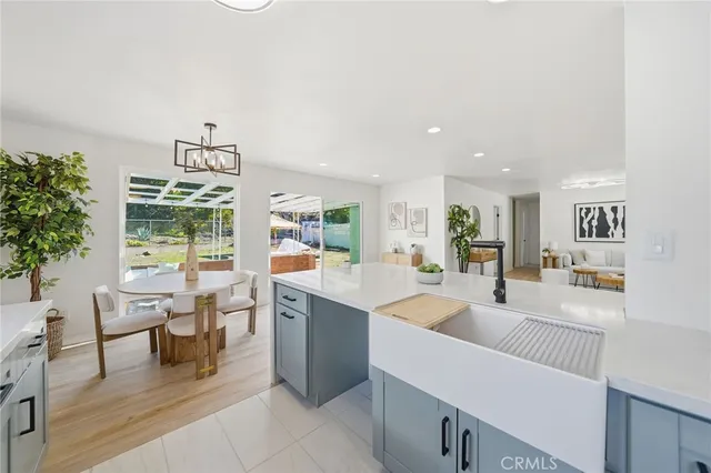 a large white kitchen with a large window