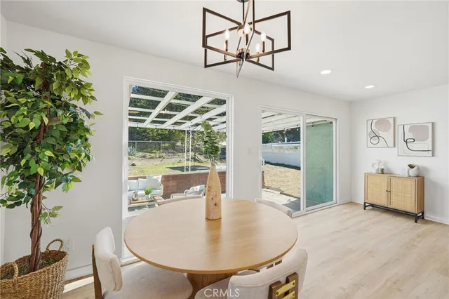 a dining room with furniture window and wooden floor