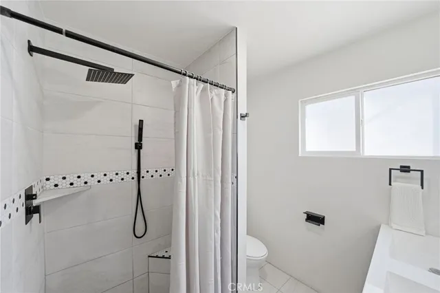a bathroom with a shower and a glass door