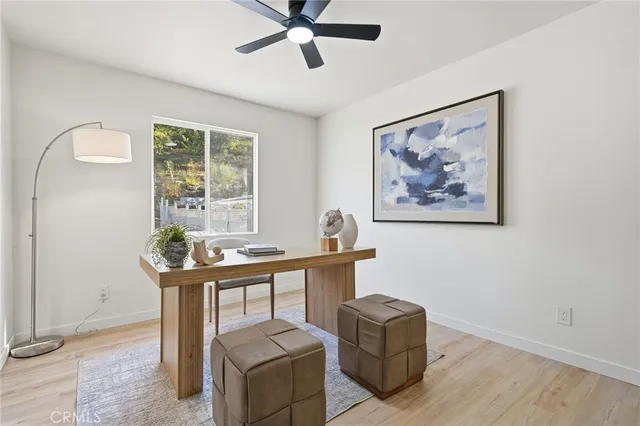a view of a workspace with furniture and window