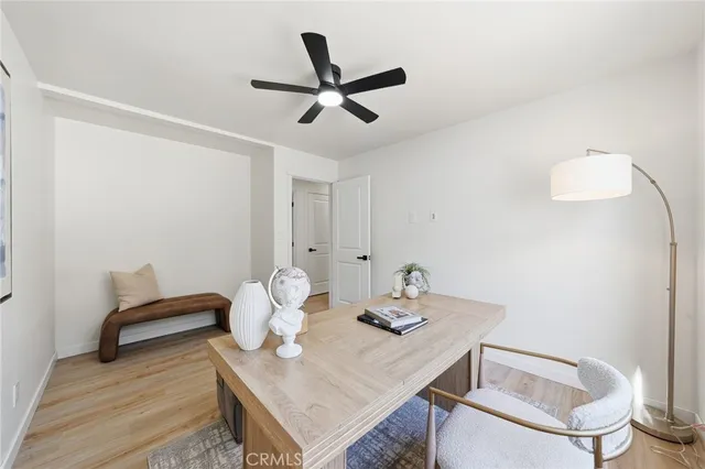 a view of a workspace with furniture and wooden floor