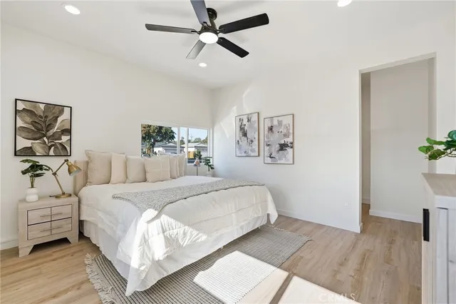 a bedroom with a large bed and a chandelier
