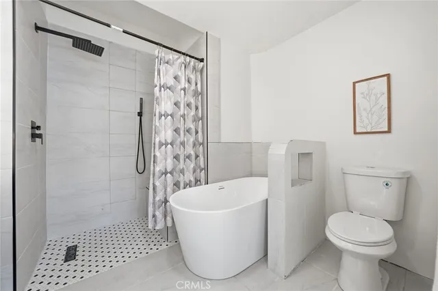 a bathroom with a toilet and shower