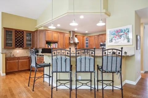 a kitchen with stainless steel appliances granite countertop a refrigerator stove and sink