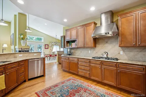 a kitchen with stainless steel appliances granite countertop a sink and cabinets