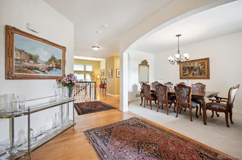 a living room with lots of furniture and painting on the wall