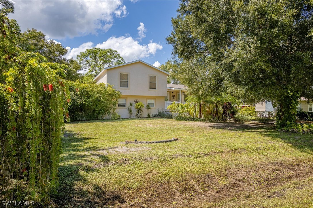 2313 Hamilton Avenue Alva, FL 33920 - Photo 1 of 30 a front view of a house with a yard and trees