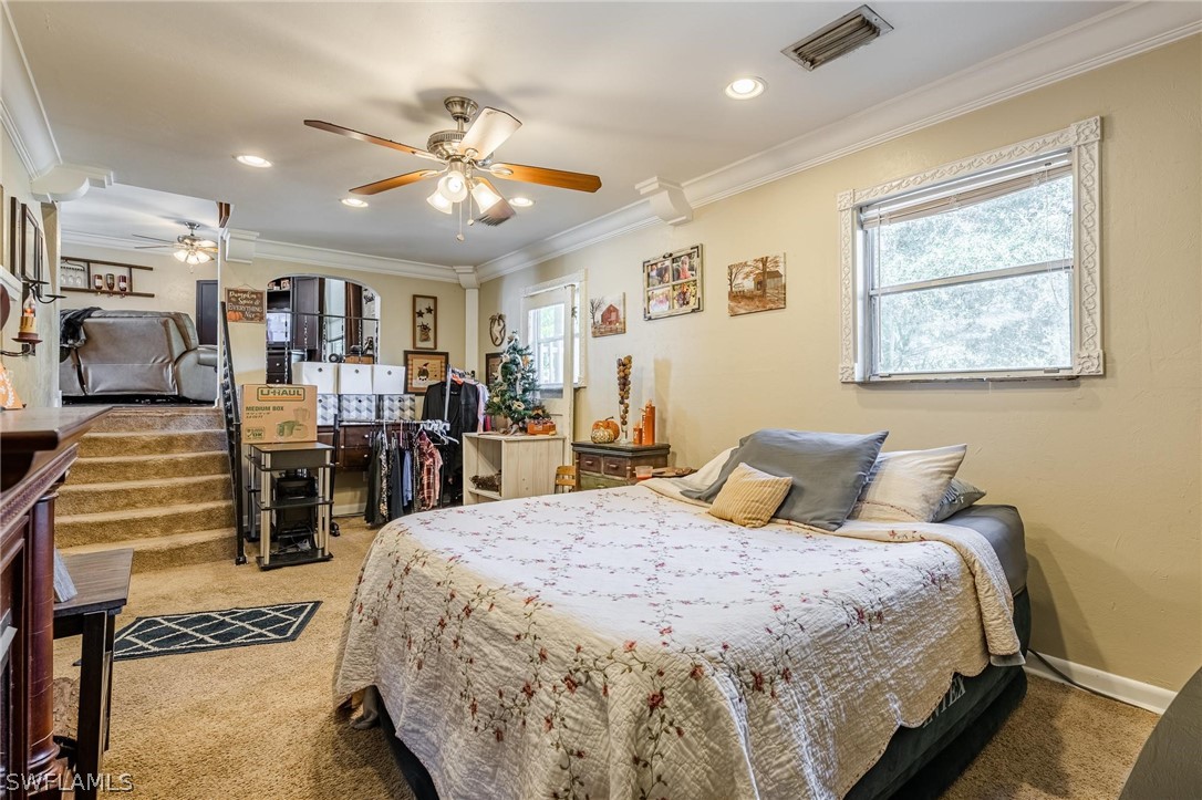 2313 Hamilton Avenue Alva, FL 33920 - Photo 11 of 30 a bedroom with a large bed and a chandelier
