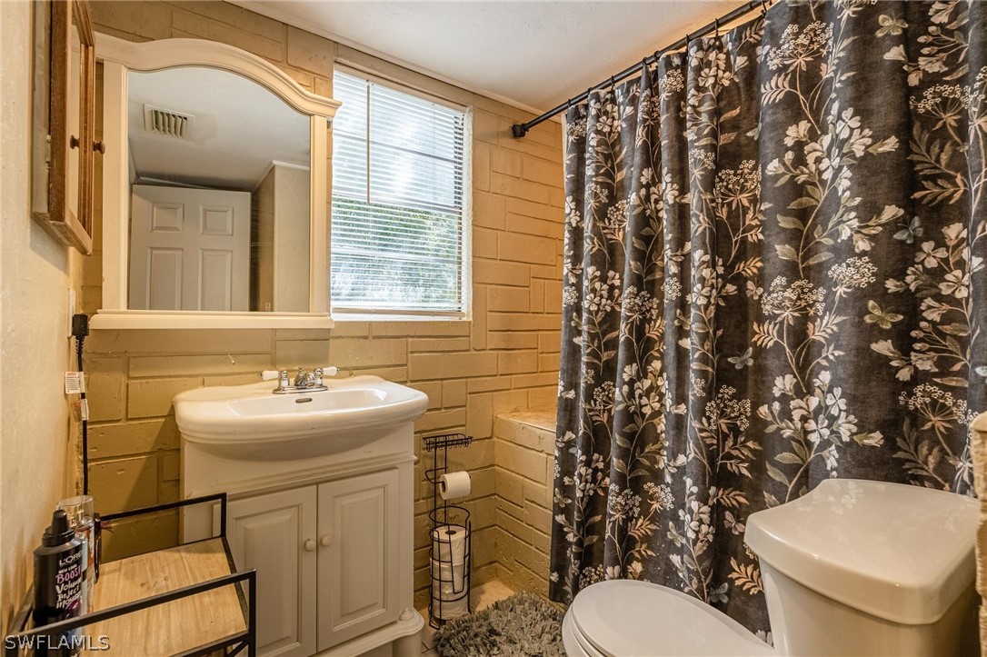 2313 Hamilton Avenue Alva, FL 33920 - Photo 12 of 30 a bathroom with a sink toilet and mirror
