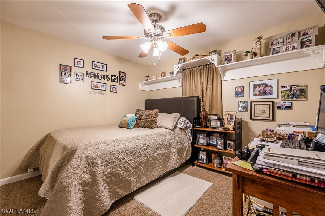 2313 Hamilton Avenue Alva, FL 33920 - Photo 20 of 30 a bedroom with a bed and wooden floor