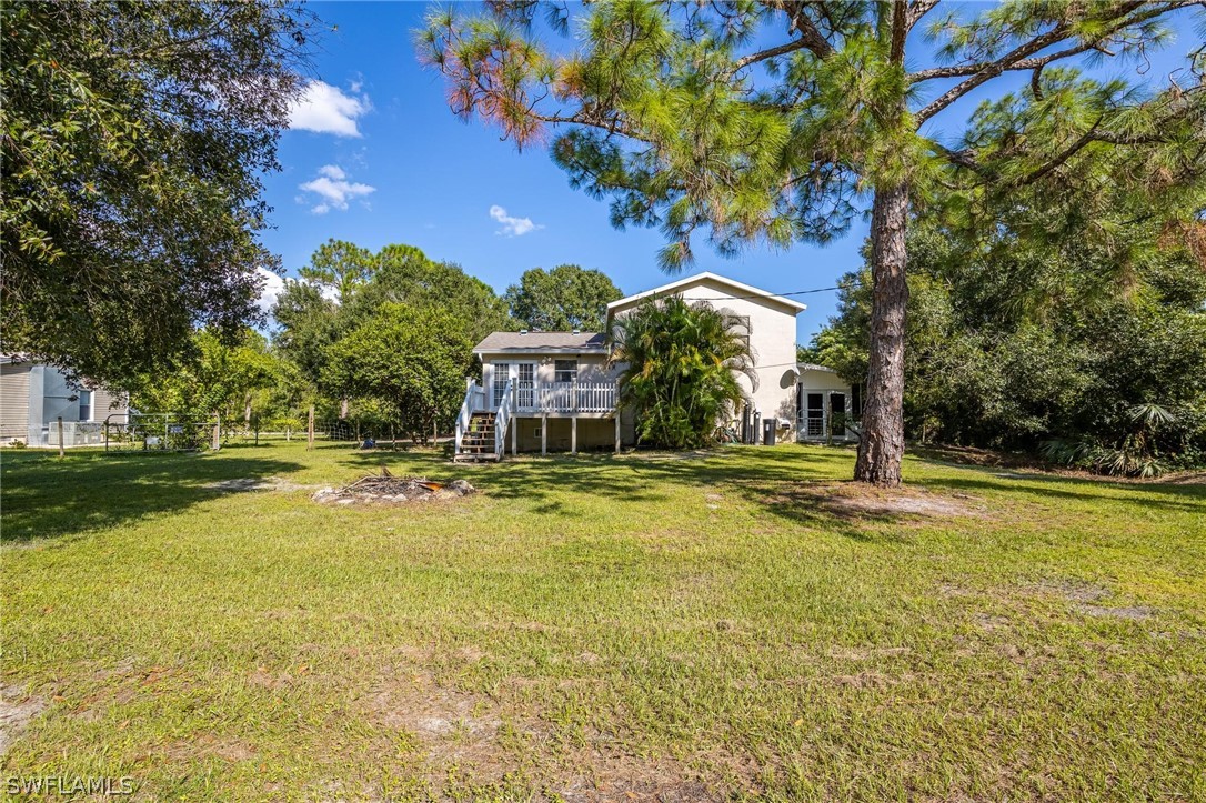 2313 Hamilton Avenue Alva, FL 33920 - Photo 23 of 30 a view of a swimming pool with lawn chairs and plants