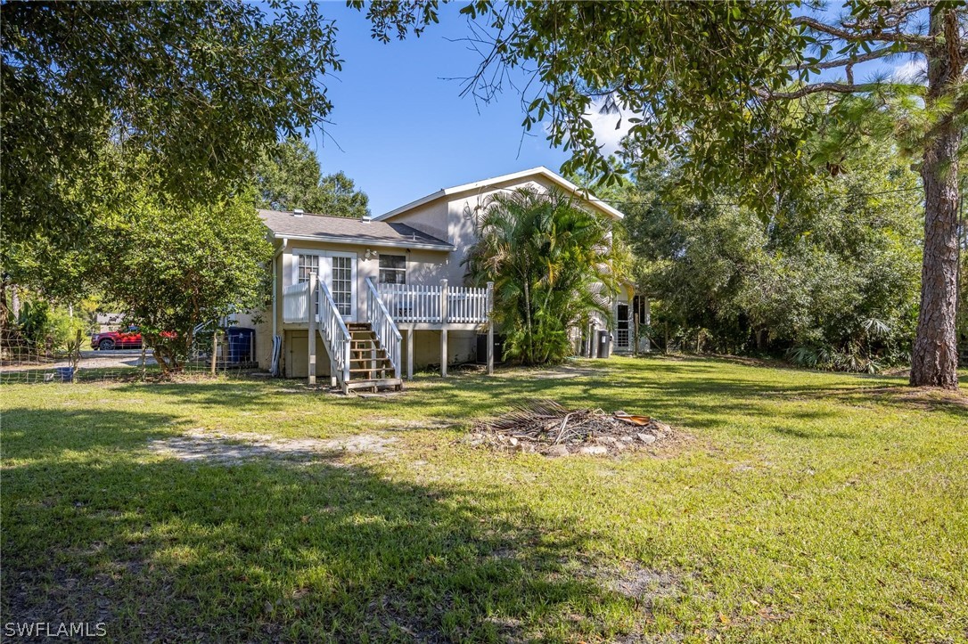 2313 Hamilton Avenue Alva, FL 33920 - Photo 24 of 30 a view of a big house with a big yard and large trees
