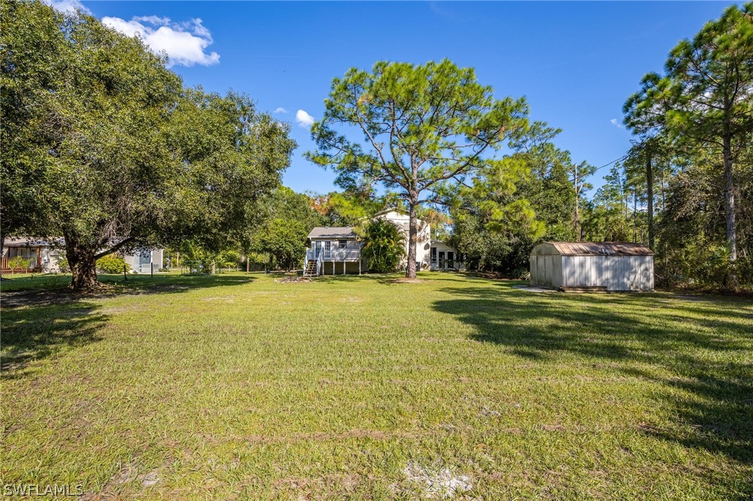 2313 Hamilton Avenue Alva, FL 33920 - Photo 25 of 30 a garden with trees in front of it