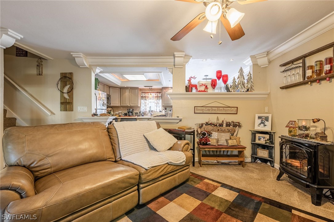 2313 Hamilton Avenue Alva, FL 33920 - Photo 8 of 30 a living room with furniture a fireplace and a chandelier