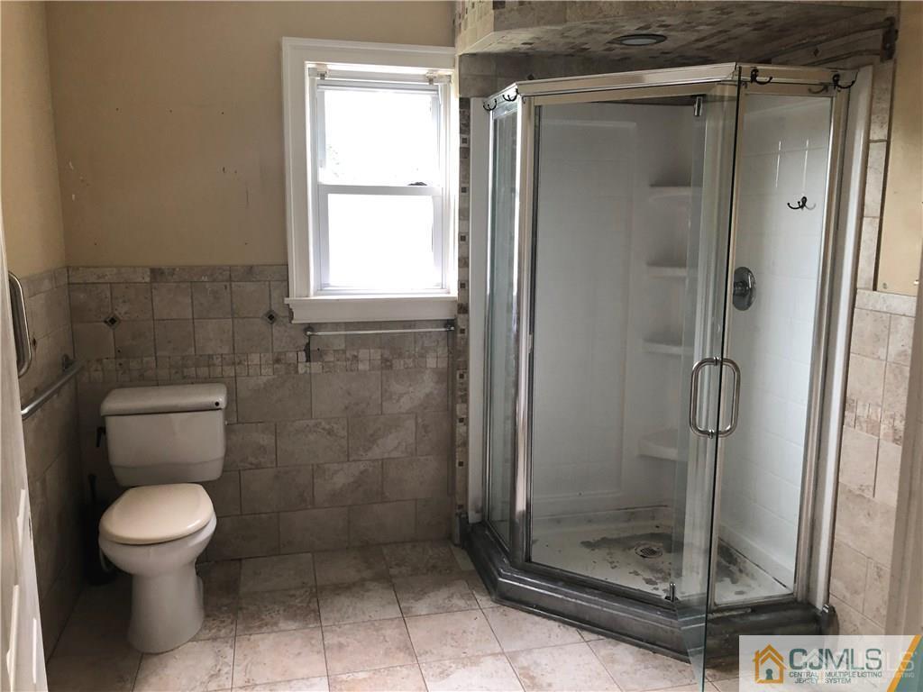 182 Prospect Plains Road Monroe Township, NJ 08831 - Photo 13 of 22 a bathroom with a toilet and a shower