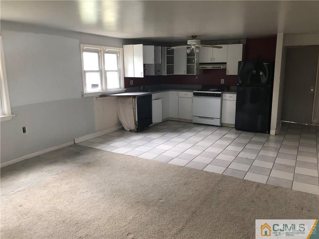 182 Prospect Plains Road Monroe Township, NJ 08831 - Photo 18 of 22 a kitchen with stainless steel appliances kitchen island granite countertop a sink stove and cabinets