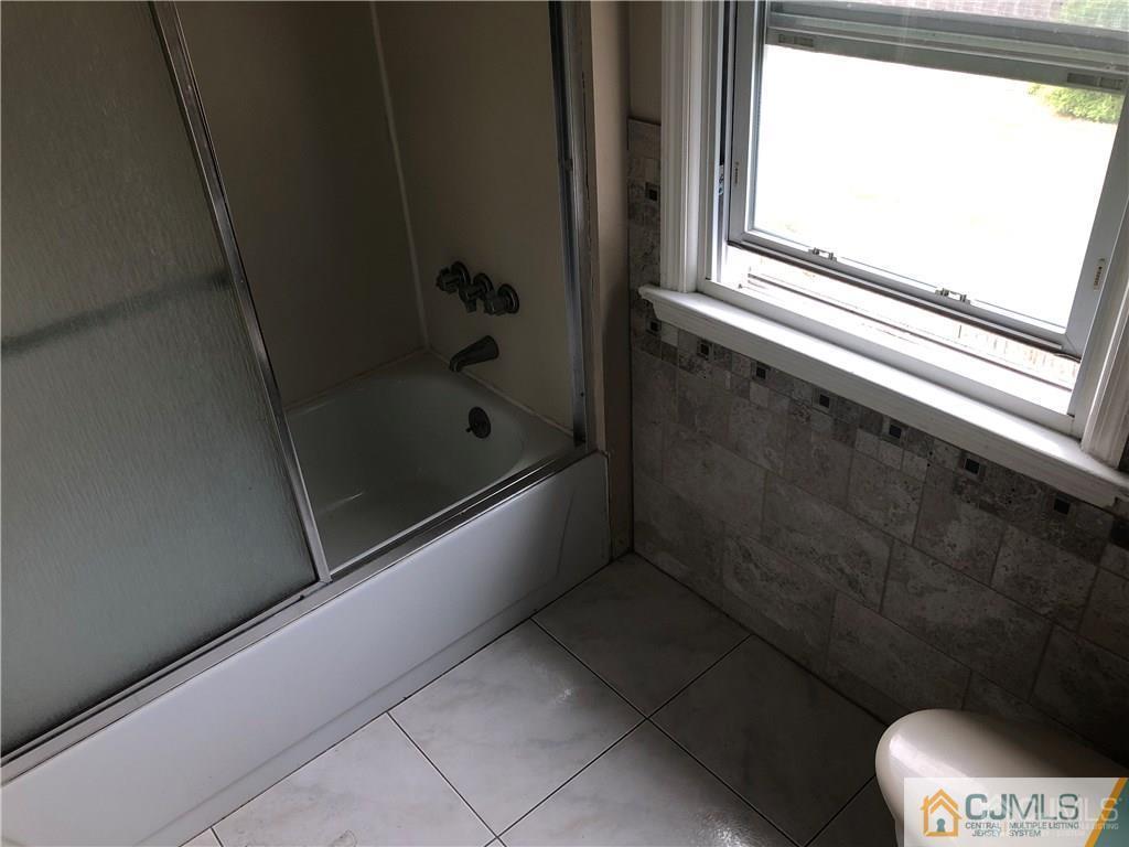 182 Prospect Plains Road Monroe Township, NJ 08831 - Photo 20 of 22 a bathroom with a bathtub