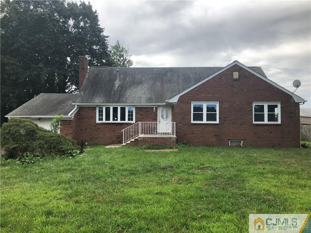 182 Prospect Plains Road Monroe Township, NJ 08831 - Photo 2 of 22 a front view of a house with a garden