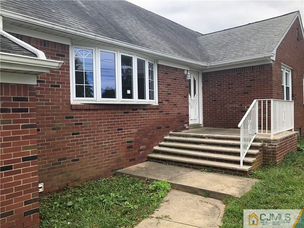 182 Prospect Plains Road Monroe Township, NJ 08831 - Photo 3 of 22 a front view of a house with a garden