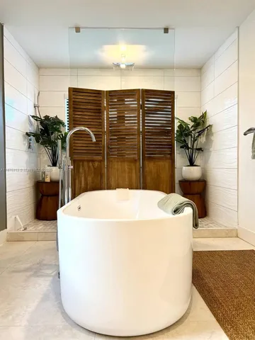 a bedroom with a bed and a large mirror